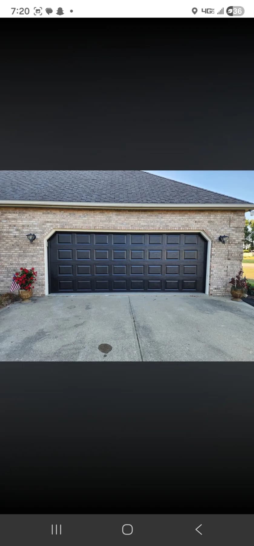 Recently replaced black garage door on a residential home